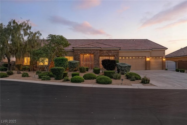 7330 Silent Water Way, Las Vegas, NV 89149 - view of front of property with an attached garage, driveway, and stone siding
