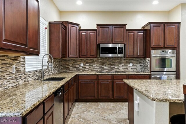 7330 Silent Water Way, Las Vegas, NV 89149 - kitchen featuring appliances with stainless steel finishes, backsplash, light stone countertops, recessed lighting, and light tile patterned floors