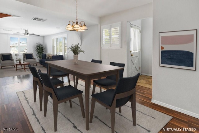 7221 Alta Dr, Las Vegas, NV 89145 - dining space with wood finished floors, a ceiling fan, and a chandelier