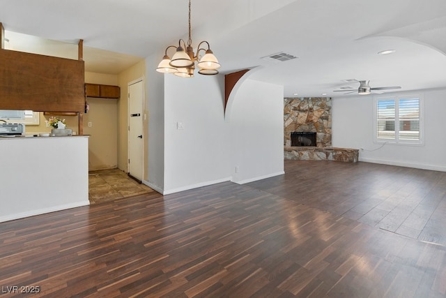 7221 Alta Dr, Las Vegas, NV 89145 - unfurnished living room with ceiling fan, wood finished floors, a stone fireplace, a chandelier, and recessed lighting