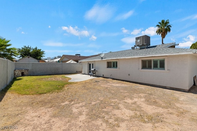 7221 Alta Dr, Las Vegas, NV 89145 - back of property with a fenced backyard, a patio area, stucco siding, and a shingled roof