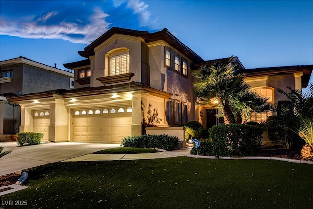 109 N Buteo Woods Ln, Las Vegas, NV 89144 - mediterranean / spanish house with stucco siding, driveway, an attached garage, and a front yard
