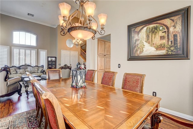 109 N Buteo Woods Ln, Las Vegas, NV 89144 - dining room featuring a chandelier, ornamental molding, wood finished floors, and a towering ceiling