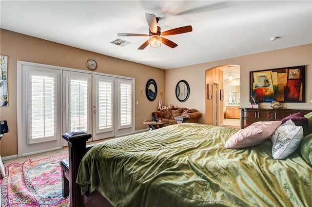 109 N Buteo Woods Ln, Las Vegas, NV 89144 - bedroom featuring access to outside, arched walkways, connected bathroom, light carpet, and ceiling fan