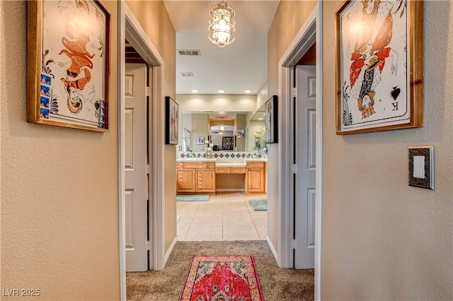 109 N Buteo Woods Ln, Las Vegas, NV 89144 - hall featuring light colored carpet, light tile patterned floors, and a textured wall