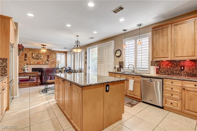 109 N Buteo Woods Ln, Las Vegas, NV 89144 - kitchen with stainless steel dishwasher, a kitchen island, open floor plan, light tile patterned floors, and recessed lighting
