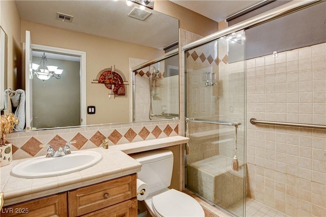109 N Buteo Woods Ln, Las Vegas, NV 89144 - bathroom featuring vanity, a shower stall, a chandelier, and backsplash