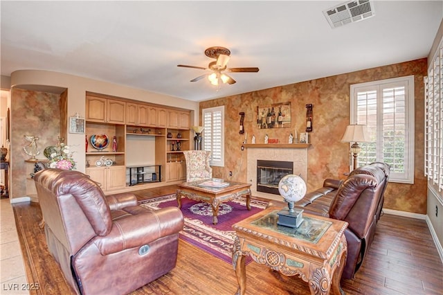 109 N Buteo Woods Ln, Las Vegas, NV 89144 - living room with ceiling fan, a tile fireplace, and wood-type flooring