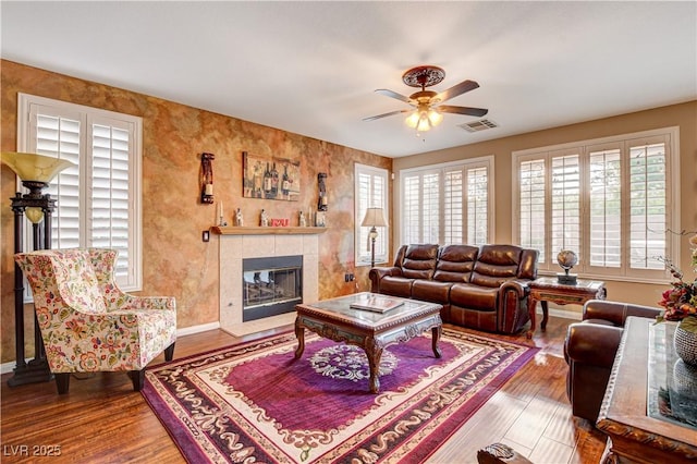 109 N Buteo Woods Ln, Las Vegas, NV 89144 - living room with wood finished floors, a ceiling fan, and a tile fireplace
