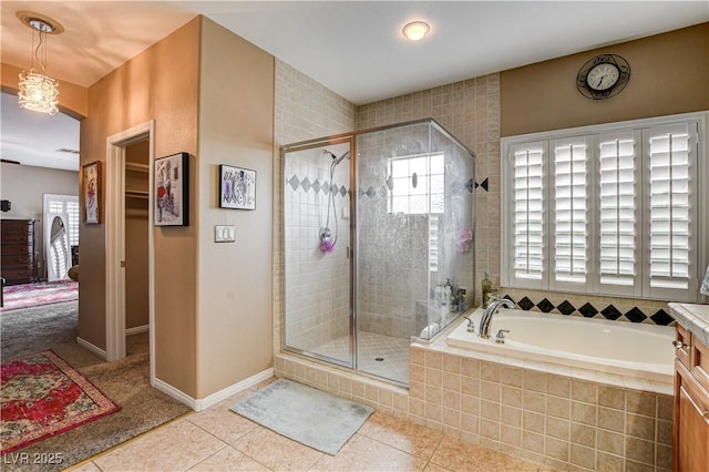 109 N Buteo Woods Ln, Las Vegas, NV 89144 - bathroom with tile patterned floors, a stall shower, a garden tub, and vanity