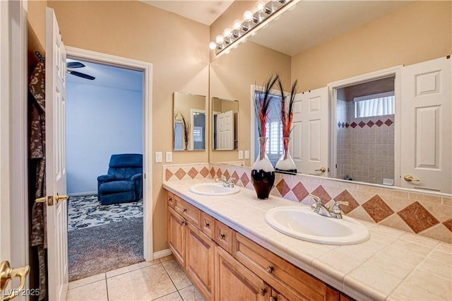 109 N Buteo Woods Ln, Las Vegas, NV 89144 - full bathroom featuring double vanity, tile patterned floors, and backsplash