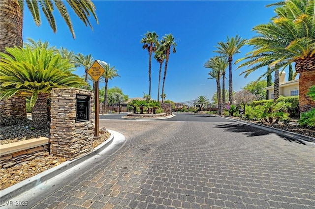 109 N Buteo Woods Ln, Las Vegas, NV 89144 - view of street with curbs, a gated entry, traffic signs, and a gate