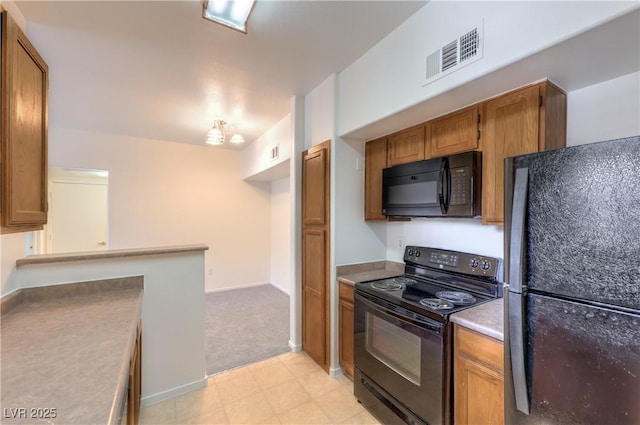 7255 W Sunset Rd Unit 1099, Las Vegas, NV 89113 - kitchen with black appliances, brown cabinets, light flooring, and light countertops