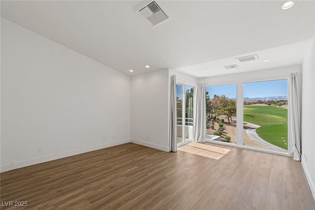 1613 Iron Ridge Dr, Las Vegas, NV 89117 - empty room featuring wood finished floors, recessed lighting, and view of golf course
