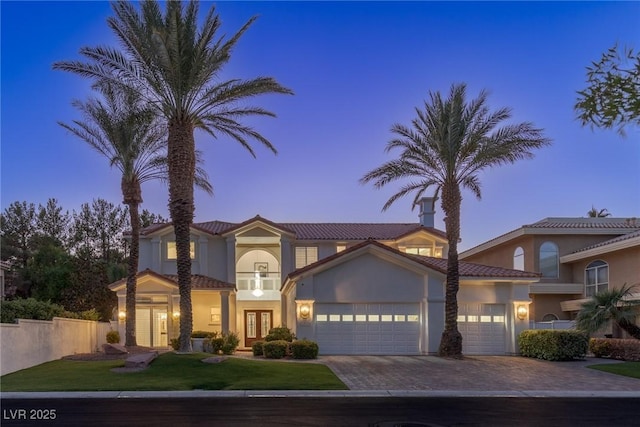 1613 Iron Ridge Dr, Las Vegas, NV 89117 - mediterranean / spanish house with french doors, a garage, decorative driveway, stucco siding, and a front lawn