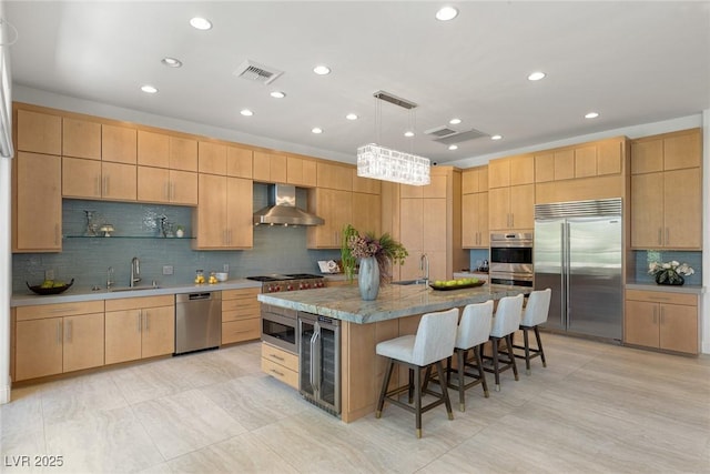 1613 Iron Ridge Dr, Las Vegas, NV 89117 - kitchen featuring built in appliances, wall chimney range hood, wine cooler, backsplash, and a breakfast bar area