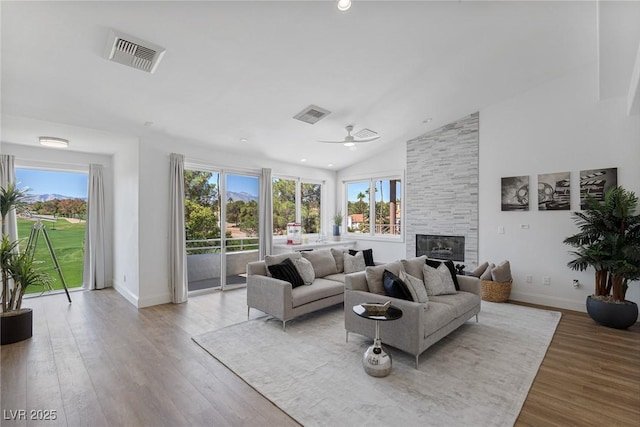 1613 Iron Ridge Dr, Las Vegas, NV 89117 - living area featuring a fireplace, a ceiling fan, light wood-type flooring, and high vaulted ceiling