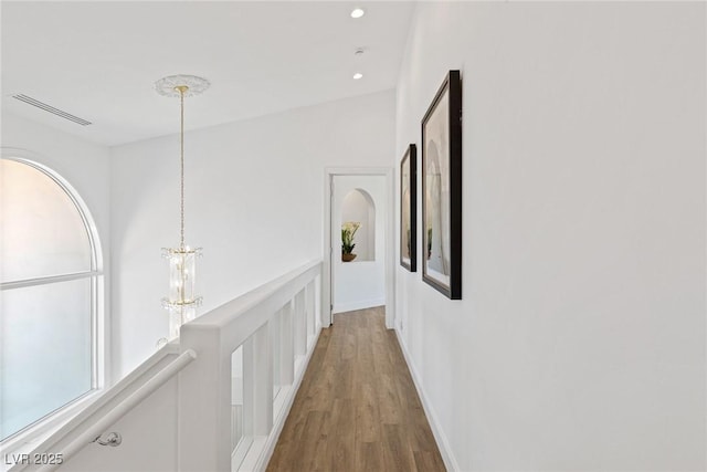 1613 Iron Ridge Dr, Las Vegas, NV 89117 - corridor featuring wood finished floors, an upstairs landing, a chandelier, and recessed lighting