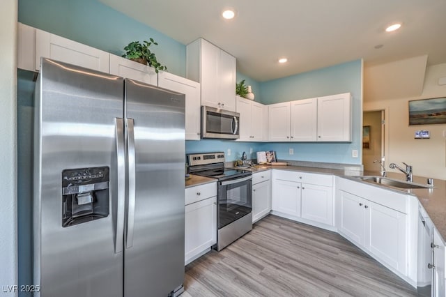 7955 Pandora Sky St Unit 362, North Las Vegas, NV 89084 - kitchen with stainless steel appliances, white cabinetry, recessed lighting, light wood-type flooring, and a peninsula