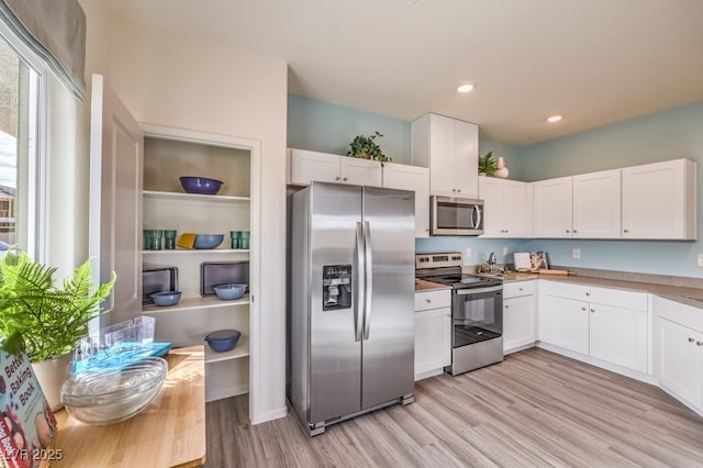 7955 Pandora Sky St Unit 362, North Las Vegas, NV 89084 - kitchen with stainless steel appliances, light wood finished floors, white cabinetry, light countertops, and recessed lighting