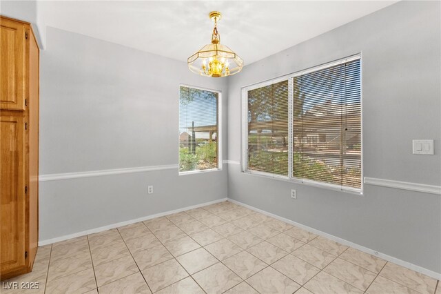 5710 E Tropicana Ave Unit 1035, Las Vegas, NV 89122 - unfurnished room featuring a chandelier and baseboards