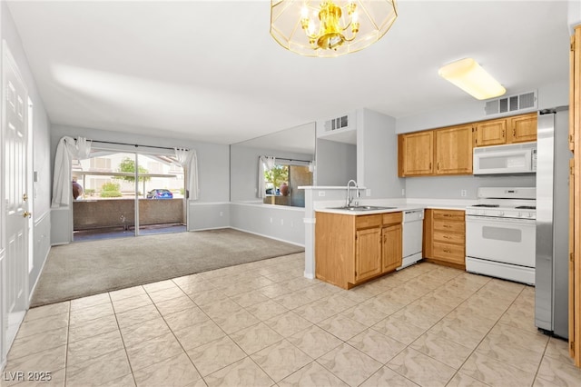 5710 E Tropicana Ave Unit 1035, Las Vegas, NV 89122 - kitchen featuring white appliances, light carpet, a peninsula, light countertops, and open floor plan