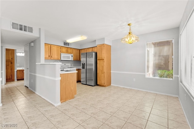 5710 E Tropicana Ave Unit 1035, Las Vegas, NV 89122 - kitchen featuring white appliances, light countertops, a peninsula, pendant lighting, and light tile patterned flooring