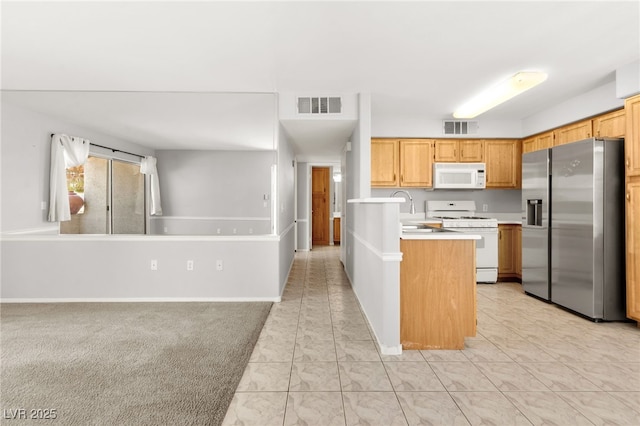 5710 E Tropicana Ave Unit 1035, Las Vegas, NV 89122 - kitchen featuring white appliances, light countertops, a peninsula, and open floor plan