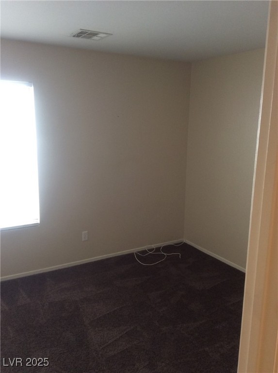 7864 Nesting Pine Pl, Las Vegas, NV 89143 - spare room featuring dark colored carpet and baseboards