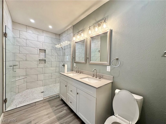 9000 Las Vegas Blvd Unit 1078, Las Vegas, NV 89123 - full bath featuring double vanity, a tile shower, wood finished floors, a textured wall, and recessed lighting