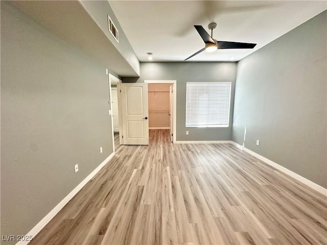 9000 Las Vegas Blvd Unit 1078, Las Vegas, NV 89123 - unfurnished bedroom featuring light wood-type flooring, a walk in closet, and a ceiling fan