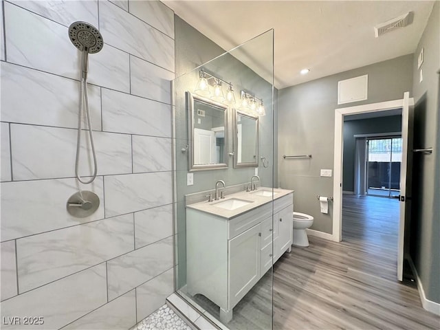 9000 Las Vegas Blvd Unit 1078, Las Vegas, NV 89123 - bathroom featuring wood finished floors, a tile shower, double vanity, and recessed lighting