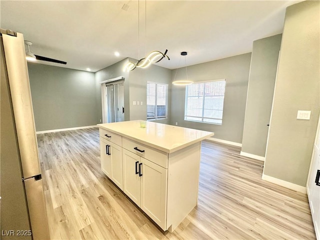 9000 Las Vegas Blvd Unit 1078, Las Vegas, NV 89123 - kitchen with open floor plan, light wood-style flooring, white cabinetry, a kitchen island, and hanging light fixtures