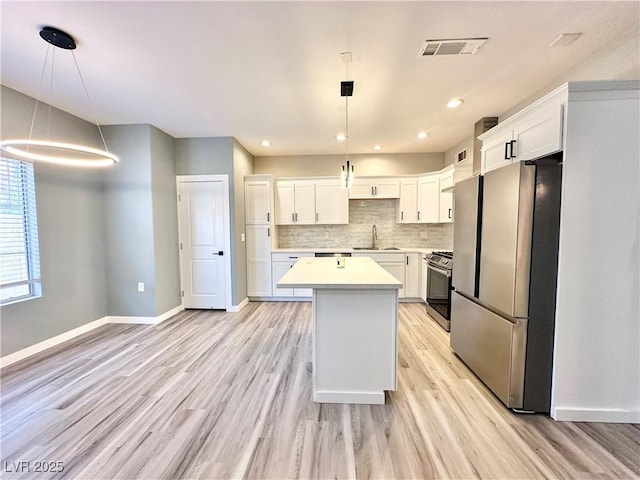 9000 Las Vegas Blvd Unit 1078, Las Vegas, NV 89123 - kitchen with appliances with stainless steel finishes, a center island, light countertops, light wood finished floors, and tasteful backsplash