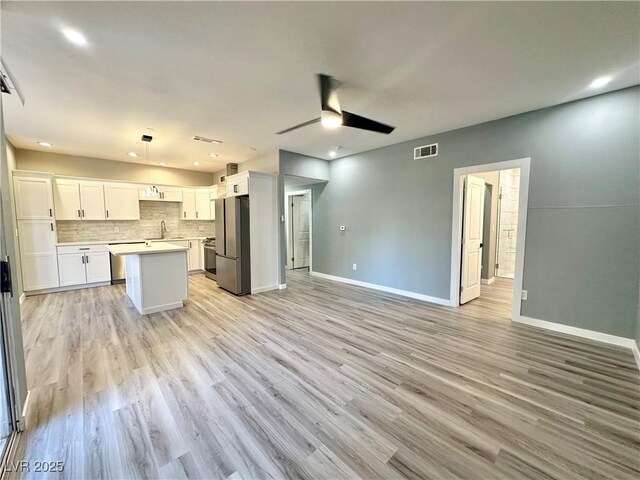 9000 Las Vegas Blvd Unit 1078, Las Vegas, NV 89123 - kitchen with freestanding refrigerator, open floor plan, a ceiling fan, backsplash, and a kitchen island