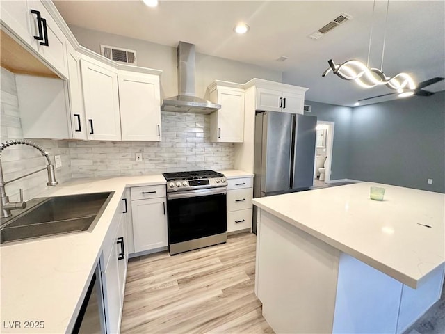 9000 Las Vegas Blvd Unit 1078, Las Vegas, NV 89123 - kitchen with appliances with stainless steel finishes, wall chimney range hood, tasteful backsplash, white cabinetry, and recessed lighting