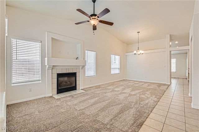 3308 Morning Wind Ln, Las Vegas, NV 89129 - unfurnished living room featuring light carpet, a ceiling fan, lofted ceiling, a fireplace, and light tile patterned flooring