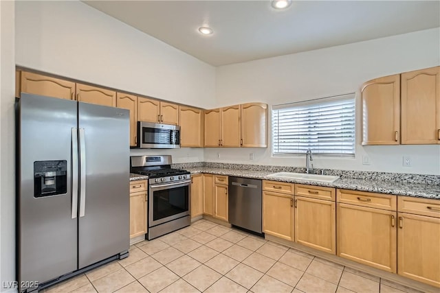 3308 Morning Wind Ln, Las Vegas, NV 89129 - kitchen featuring stainless steel appliances, light brown cabinets, light tile patterned flooring, light stone counters, and recessed lighting