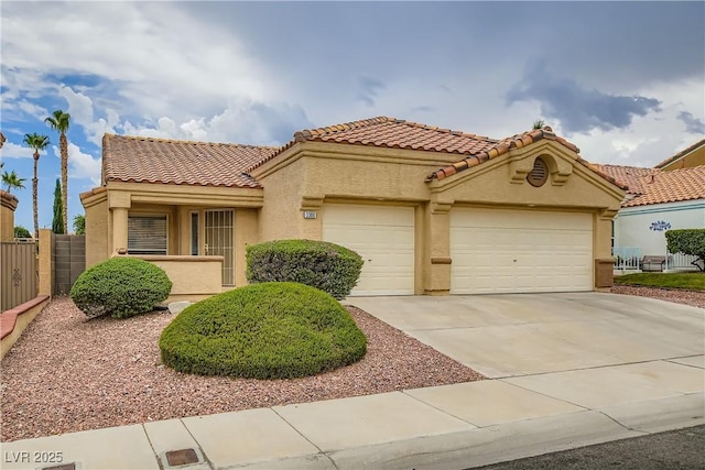 3308 Morning Wind Ln, Las Vegas, NV 89129 - mediterranean / spanish-style home with stucco siding, a garage, a tile roof, and concrete driveway