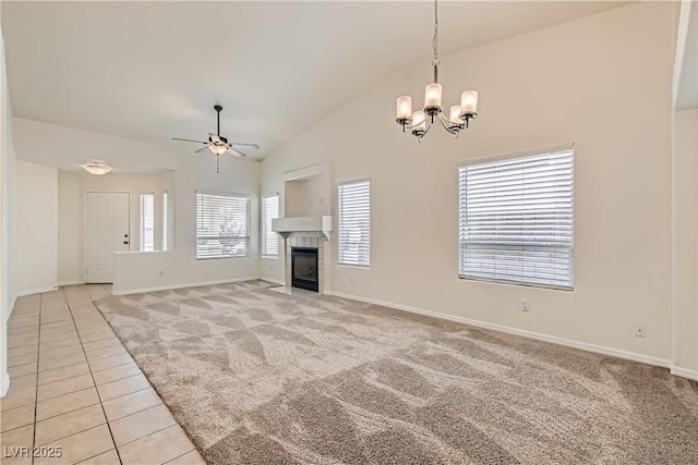3308 Morning Wind Ln, Las Vegas, NV 89129 - unfurnished living room featuring light tile patterned flooring, a chandelier, ceiling fan, light carpet, and a fireplace