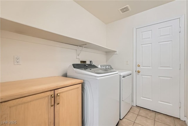 3308 Morning Wind Ln, Las Vegas, NV 89129 - laundry room with cabinet space, washer and clothes dryer, and light tile patterned floors