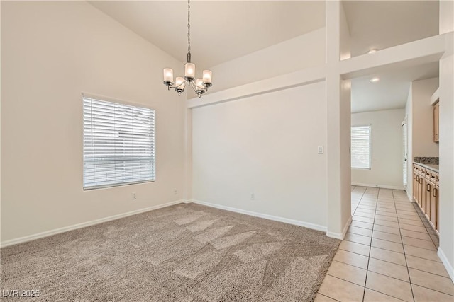 3308 Morning Wind Ln, Las Vegas, NV 89129 - empty room featuring a chandelier, light tile patterned flooring, light colored carpet, and high vaulted ceiling