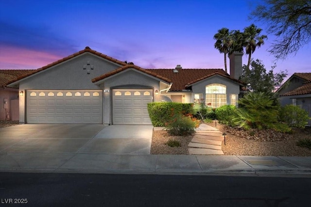 2408 Sunset Beach Ln, Las Vegas, NV 89128 - mediterranean / spanish home with a garage, a chimney, driveway, stucco siding, and a tile roof