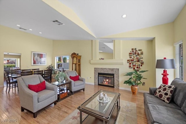 2408 Sunset Beach Ln, Las Vegas, NV 89128 - living area featuring vaulted ceiling, wood finished floors, a tiled fireplace, and recessed lighting