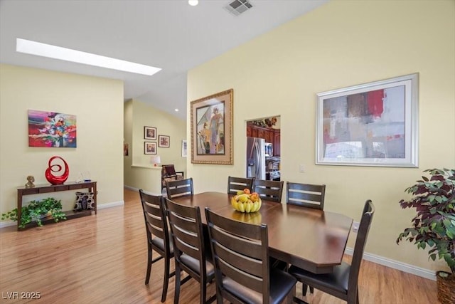 2408 Sunset Beach Ln, Las Vegas, NV 89128 - dining area featuring wood finished floors and lofted ceiling
