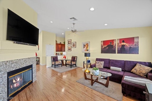 2408 Sunset Beach Ln, Las Vegas, NV 89128 - living room with vaulted ceiling, light wood-style flooring, recessed lighting, and a glass covered fireplace