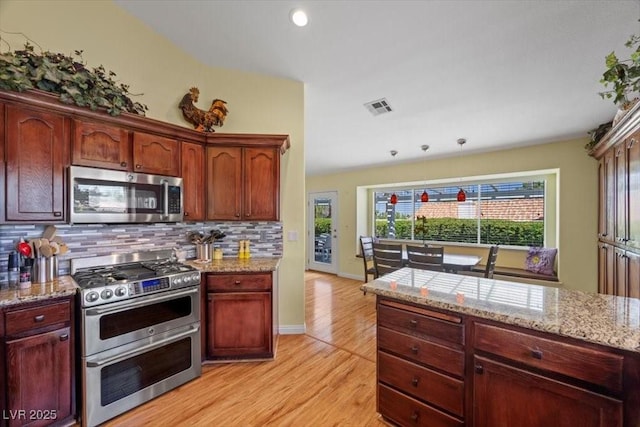 2408 Sunset Beach Ln, Las Vegas, NV 89128 - kitchen with stainless steel appliances, backsplash, light wood-style flooring, light stone counters, and recessed lighting