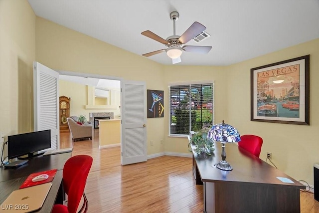2408 Sunset Beach Ln, Las Vegas, NV 89128 - office space with a fireplace, wood finished floors, and ceiling fan