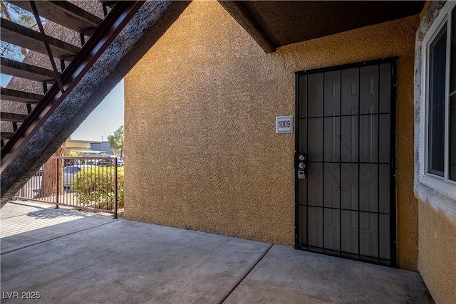 7950 W Flamingo Rd Unit 1009, Las Vegas, NV 89147 - doorway to property featuring stucco siding and a patio