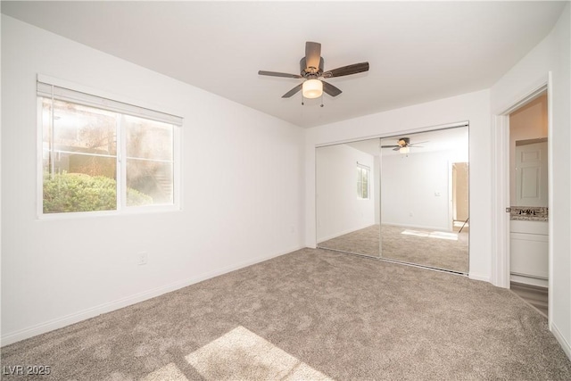 7950 W Flamingo Rd Unit 1009, Las Vegas, NV 89147 - unfurnished bedroom featuring carpet floors, multiple windows, a closet, and a ceiling fan